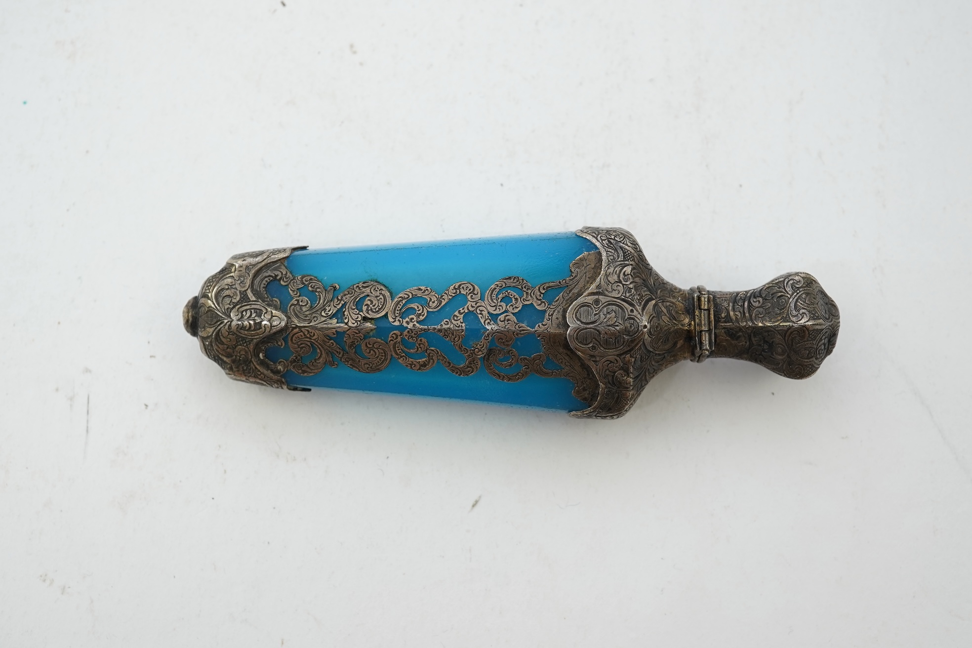 A late 19th century French white metal mounted and overlaid blue opaline glass scent flask